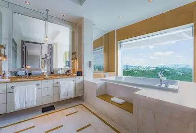 a bathroom with a tub and a large window at Hilton Kuala Lumpur in Kuala Lumpur