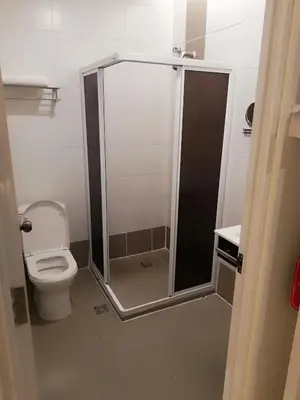 a bathroom with a toilet and a shower stall at Holiday Place Kuala Lumpur in Kuala Lumpur