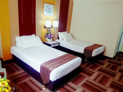 a hotel room with two beds in a room at Palace Hotel in Kuala Lumpur
