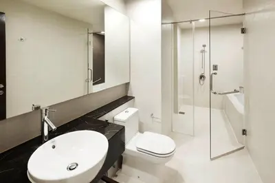a bathroom with a toilet and a sink and a shower at PARKROYAL Serviced Suites Kuala Lumpur in Kuala Lumpur