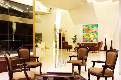 a lobby with several chairs and a table and a lobby at PARKROYAL Serviced Suites Kuala Lumpur in Kuala Lumpur