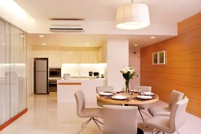 a kitchen and dining room with a table and chairs at PARKROYAL Serviced Suites Kuala Lumpur in Kuala Lumpur