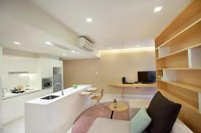 a room with a kitchen and a living room at PARKROYAL Serviced Suites Kuala Lumpur in Kuala Lumpur