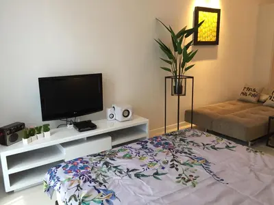 a living room with a flat screen tv and a couch at Homely Apartment with Great Facilities and Free Parking in Kuala Lumpur
