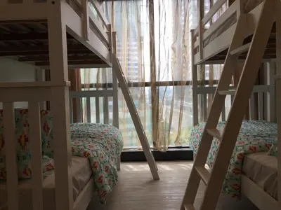 two bunk beds in a room with a window at Homely Apartment with Great Facilities and Free Parking in Kuala Lumpur