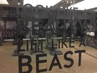 a gym with a sign that reads look like a beast at Homely Apartment with Great Facilities and Free Parking in Kuala Lumpur