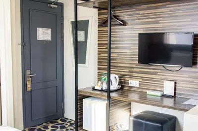 a room with a flat screen tv on a wall at The 5 Elements Hotel Chinatown Kuala Lumpur in Kuala Lumpur