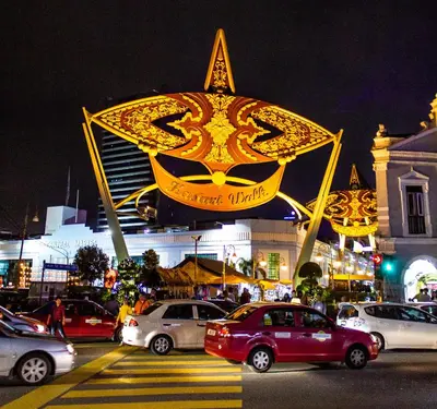 a city street with cars parked in front of a building at The 5 Elements Hotel Chinatown Kuala Lumpur in Kuala Lumpur