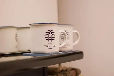 two coffee mugs sitting on top of a shelf at Tian Jing Hotel in Kuala Lumpur