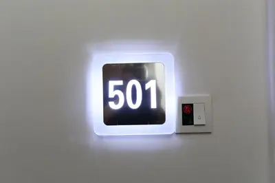 a clock on a wall with the number at M&M Hotel in Kuala Lumpur
