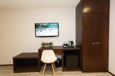a desk with a white chair in a room at M&M Hotel in Kuala Lumpur