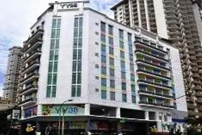 a large white building with many windows in a city at YY38 Hotel in Kuala Lumpur