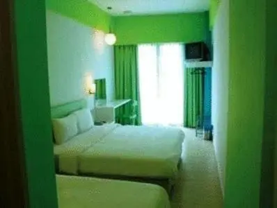 a hotel room with a bed and a window at YY38 Hotel in Kuala Lumpur