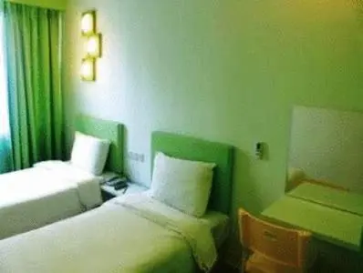 a hotel room with two beds and a window at YY38 Hotel in Kuala Lumpur