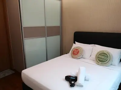 a hotel room with a bed with two towels on it at Soho Suites Klcc By Pnut KLCC VIEW in Kuala Lumpur