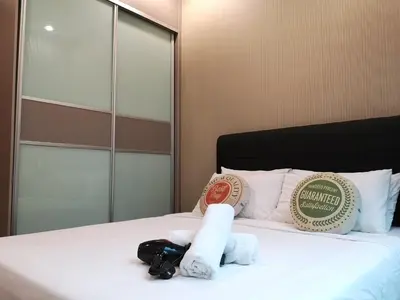 a hotel room with a bed with towels on it at Soho Suites Klcc By Pnut KLCC VIEW in Kuala Lumpur