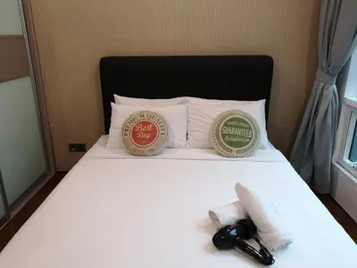 a bedroom with a bed with two pillows at Soho Suites Klcc By Pnut KLCC VIEW in Kuala Lumpur