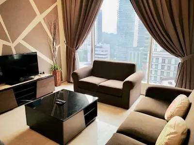 a living room with a couch and chairs and a tv at Soho Suites Klcc By Pnut KLCC VIEW in Kuala Lumpur