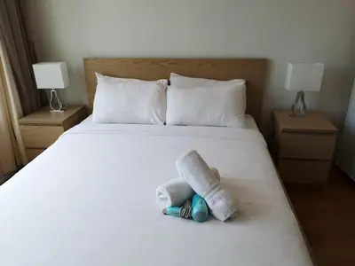 a bed with two rolled up towels on it at VORTEX SUITES KLCC by PNUT With NETFLIX in Kuala Lumpur