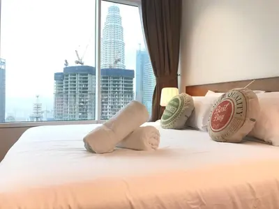 a hotel room with a bed with towels on it at VORTEX SUITES KLCC by PNUT With NETFLIX in Kuala Lumpur