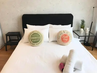 a white bed with two pillows on it at VORTEX SUITES KLCC by PNUT With NETFLIX in Kuala Lumpur