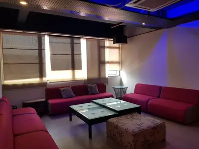 a waiting room with red couches and a coffee table at Leo Palace Hotel New Wing, WTC Kuala Lumpur in Kuala Lumpur