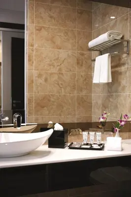 a bathroom with a white sink and a mirror at Dorsett Residences Bukit Bintang @Dorsett Kuala Lumpur in Kuala Lumpur