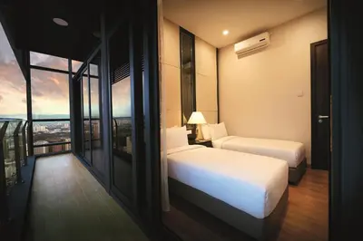 a hotel room with two beds and a balcony at Dorsett Residences Bukit Bintang @Dorsett Kuala Lumpur in Kuala Lumpur