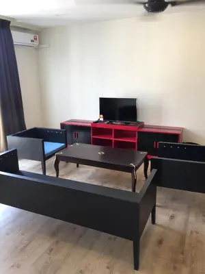 a living room with two beds and a desk at Arina Unity in Kuala Lumpur
