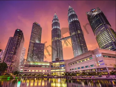 a group of skyscrapers in a city at night at 5 STAR & LUXURY Apartment near KLCC/ KL City Centre in Kuala Lumpur