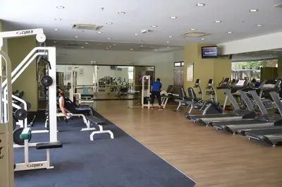 a gym with treadmills and people exercising in it at Sunbow Suites @ Times Square Kuala Lumpur in Kuala Lumpur