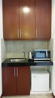 a kitchen with a sink and a microwave at Sunbow Suites @ Times Square Kuala Lumpur in Kuala Lumpur