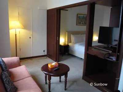 a living room with a couch and a tv and a mirror at Sunbow Suites @ Times Square Kuala Lumpur in Kuala Lumpur