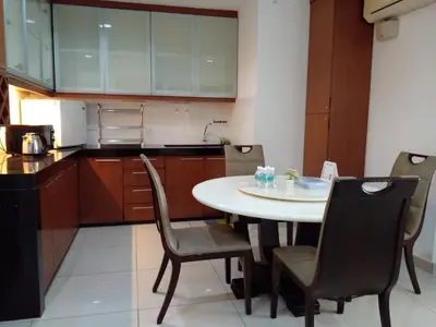 a kitchen with a table and chairs in a room at Sunbow Suites @ Times Square Kuala Lumpur in Kuala Lumpur