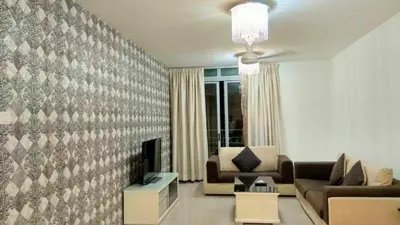 a living room with a couch and a fireplace at Taragon Putrie Bintang suites in Kuala Lumpur