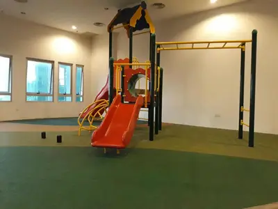a playground in a room with a red slide at Taragon Putrie Bintang suites in Kuala Lumpur