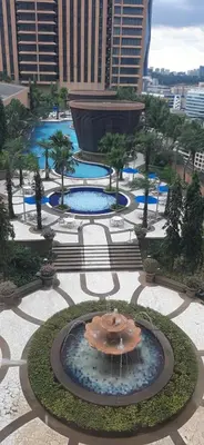 an aerial view of a fountain in a courtyard at Genius Service Suites at time square kl in Kuala Lumpur