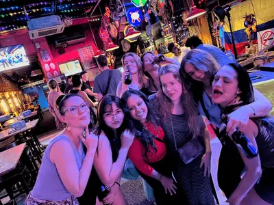 a group of women standing in a bar at Travelogue Guest House in Kuala Lumpur