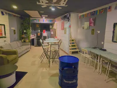 a living room with a couch and a table and chairs at Travelogue Guest House in Kuala Lumpur