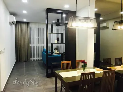 a dining room with a table and a blue couch at Sentrio Pandan Kuala Lumpur in Kuala Lumpur