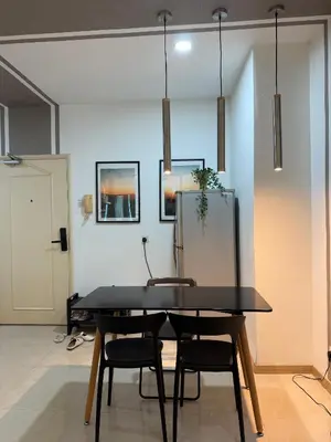 a dining room with a black table and two chairs at Parkview Suite KLCC, Myhomey in Kuala Lumpur