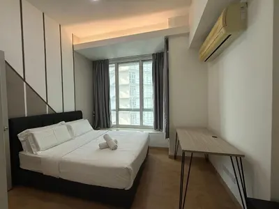a small bedroom with a bed and a window at Parkview Suite KLCC, Myhomey in Kuala Lumpur