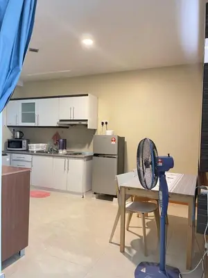 a kitchen with a table and a fan in a room at Parkview Suite KLCC, Myhomey in Kuala Lumpur