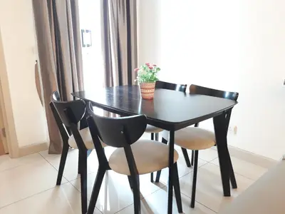a black table with four chairs and a plant on it at Royal Suite in Kuala Lumpur