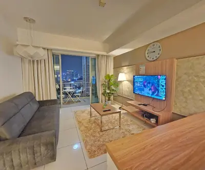 a living room with a couch and a tv at Royal Suite in Kuala Lumpur