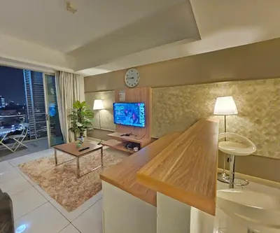 a large living room with a tv and a living room with at Royal Suite in Kuala Lumpur