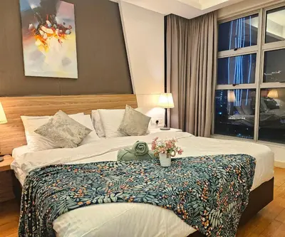 a hotel room with a bed with flowers on it at Royal Suite in Kuala Lumpur