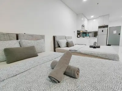 a bedroom with two beds with a towel on the floor at Inspired Homes @ Summer Suite in Kuala Lumpur