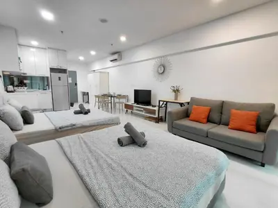 a living room with two beds and a couch at Inspired Homes @ Summer Suite in Kuala Lumpur