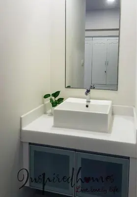 a bathroom with a white sink and a mirror at Inspired Homes @ Summer Suite in Kuala Lumpur